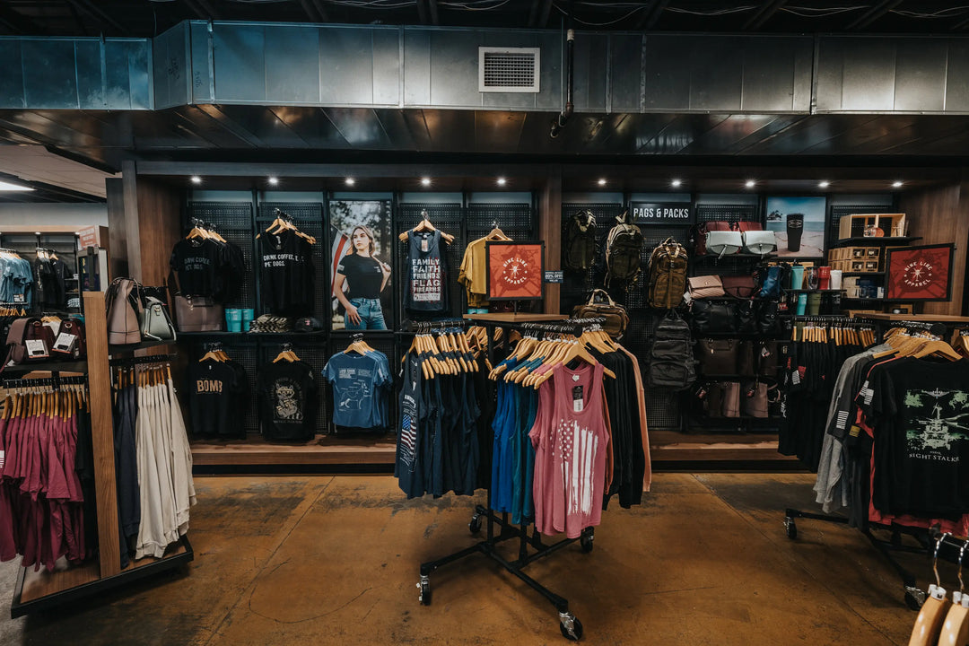 Store interior of Veteran-Owned patriotic clothing store, Nine Line Apparel HQ. Here you can see some of our graphic tees, mugs, and bags.